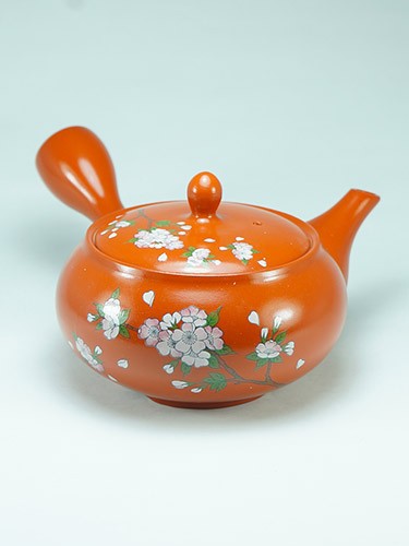 Orange teapot cherry flowers